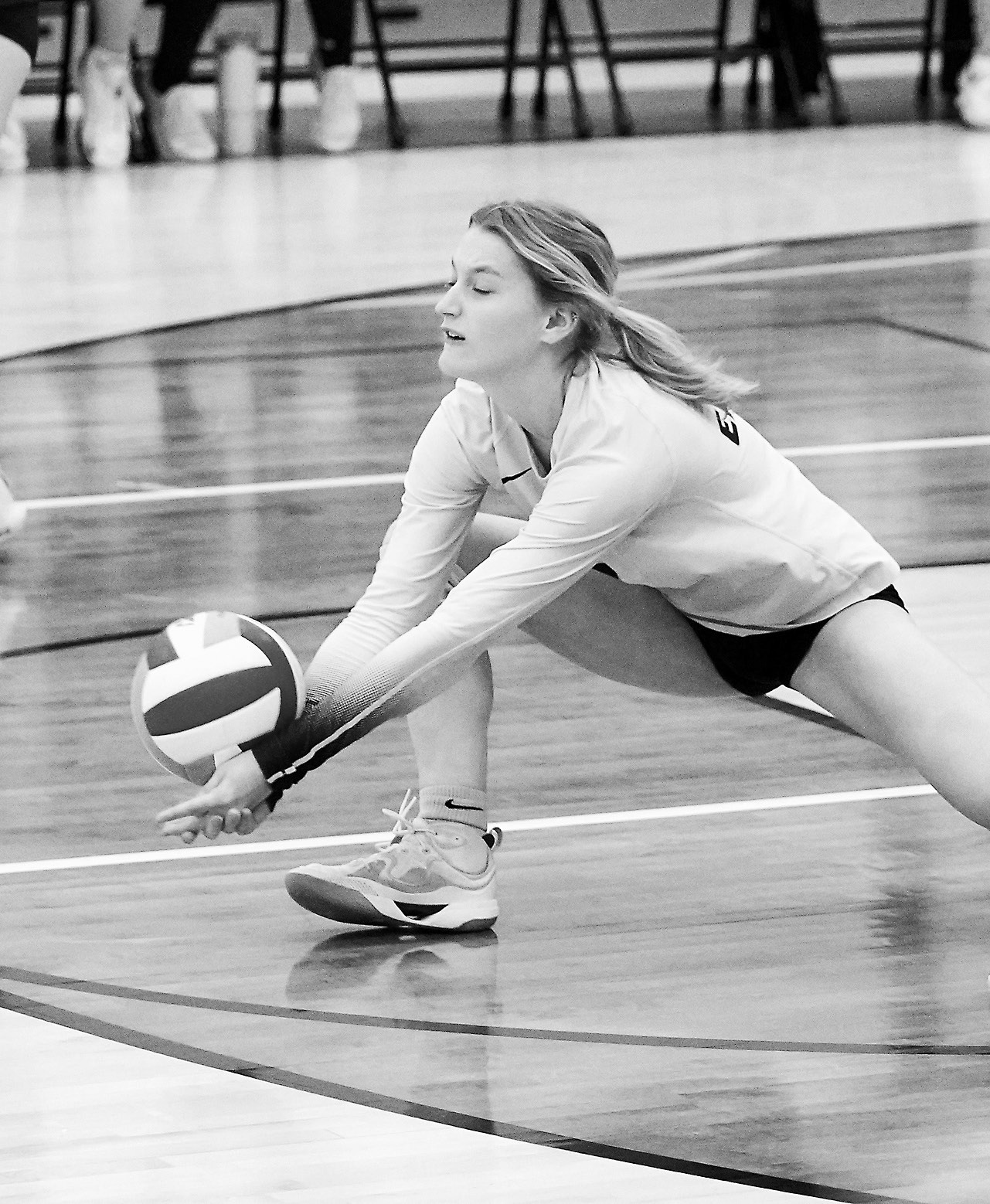 Dannika Bennett gets low to dig the ball and send it to a teammate. Photo by Larry Stokke.