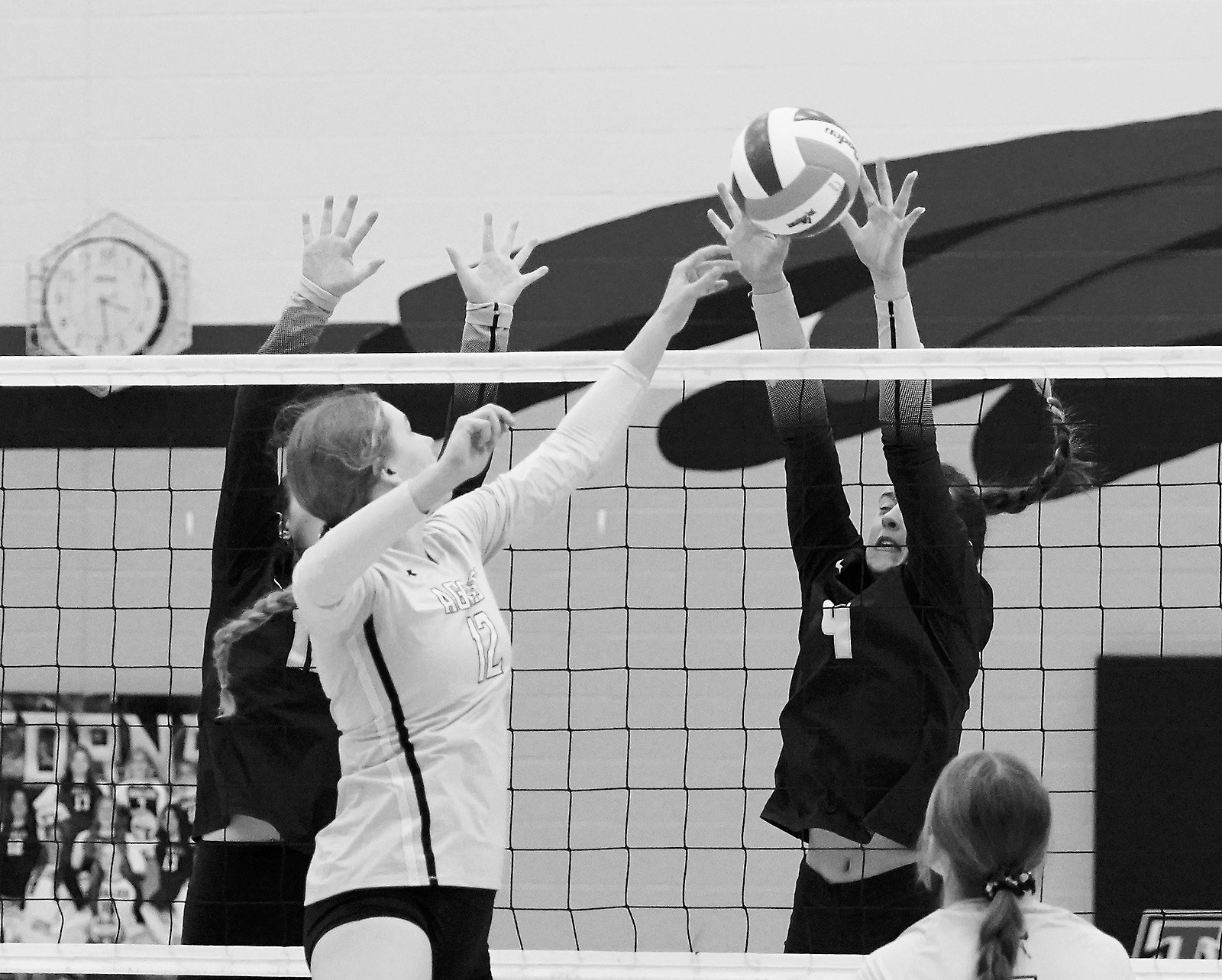 Jaelyn Johnson stuff blocks the ball in the district game against the Park River Aggies. Photo by Larry Stokke.