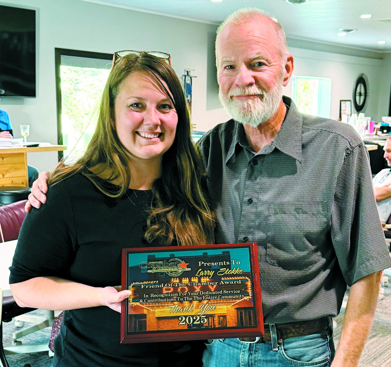 Brandi Mittleider, executive director of the Langdon Chamber of Commerce, poses with Larry Stokke and his plaque honoring him as the 2024–2025 Friend of the Chamber.
