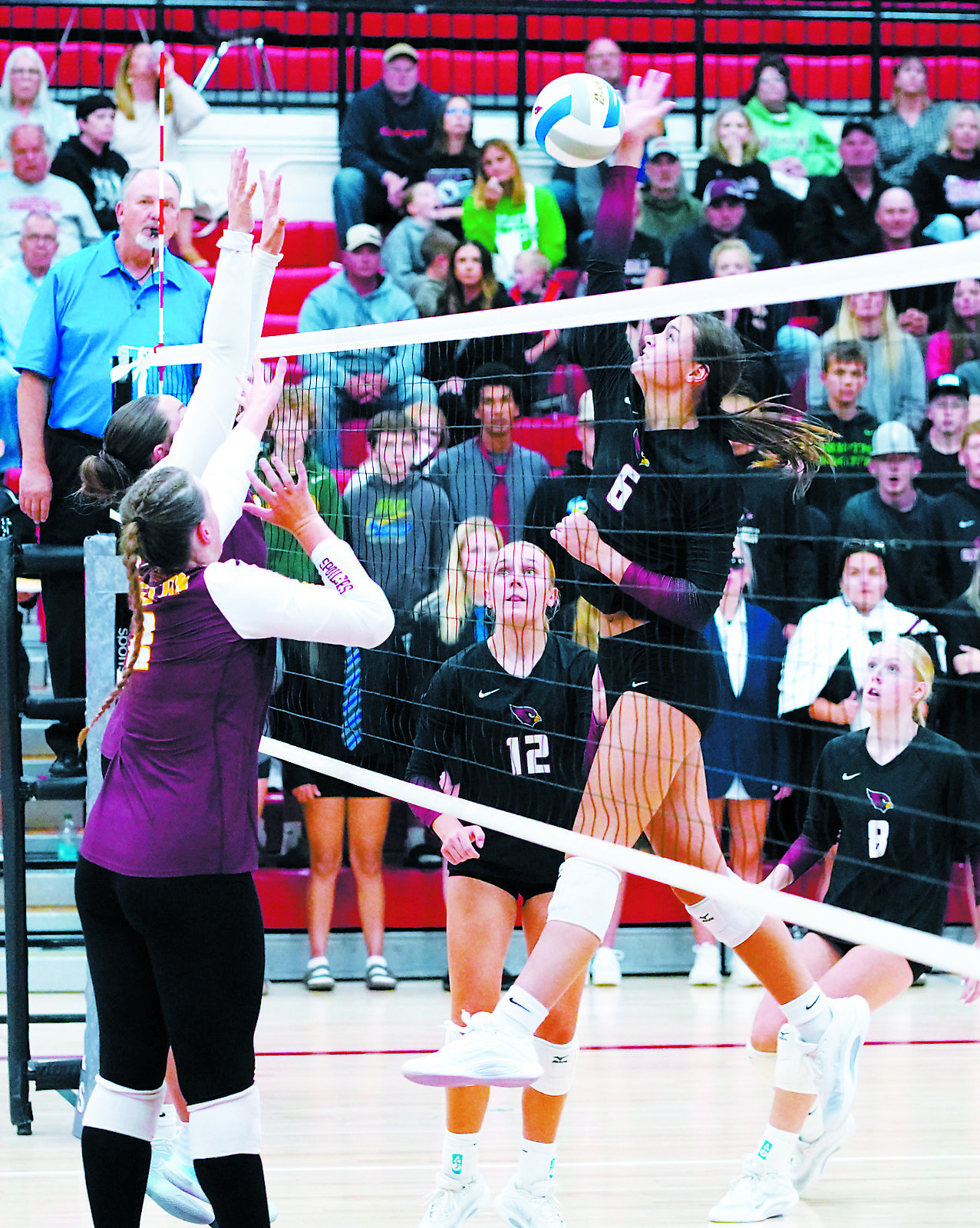 Taya Feist hammers down a kill in the win over Grafton. Photo by Larry Stokke.