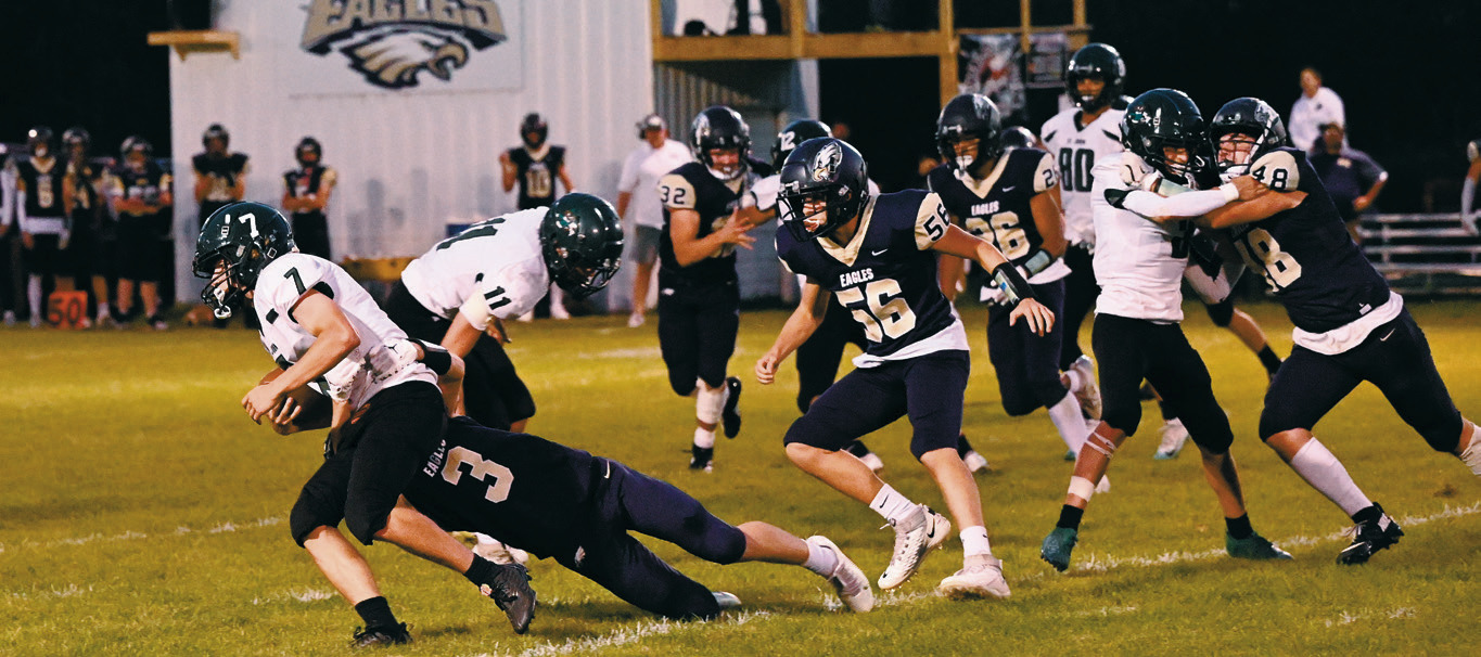 Oakley Brown gets a hand on a Woodchuck ball carrier to stall the advance. Photo by Ashley Shafer.