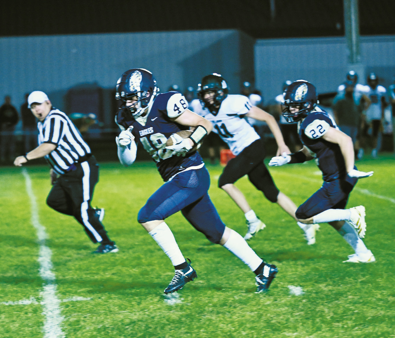 Chase Mensch on the fumble recovery, runs the ball in for a touchdown against St. John. Photo by Ashley Shafer.