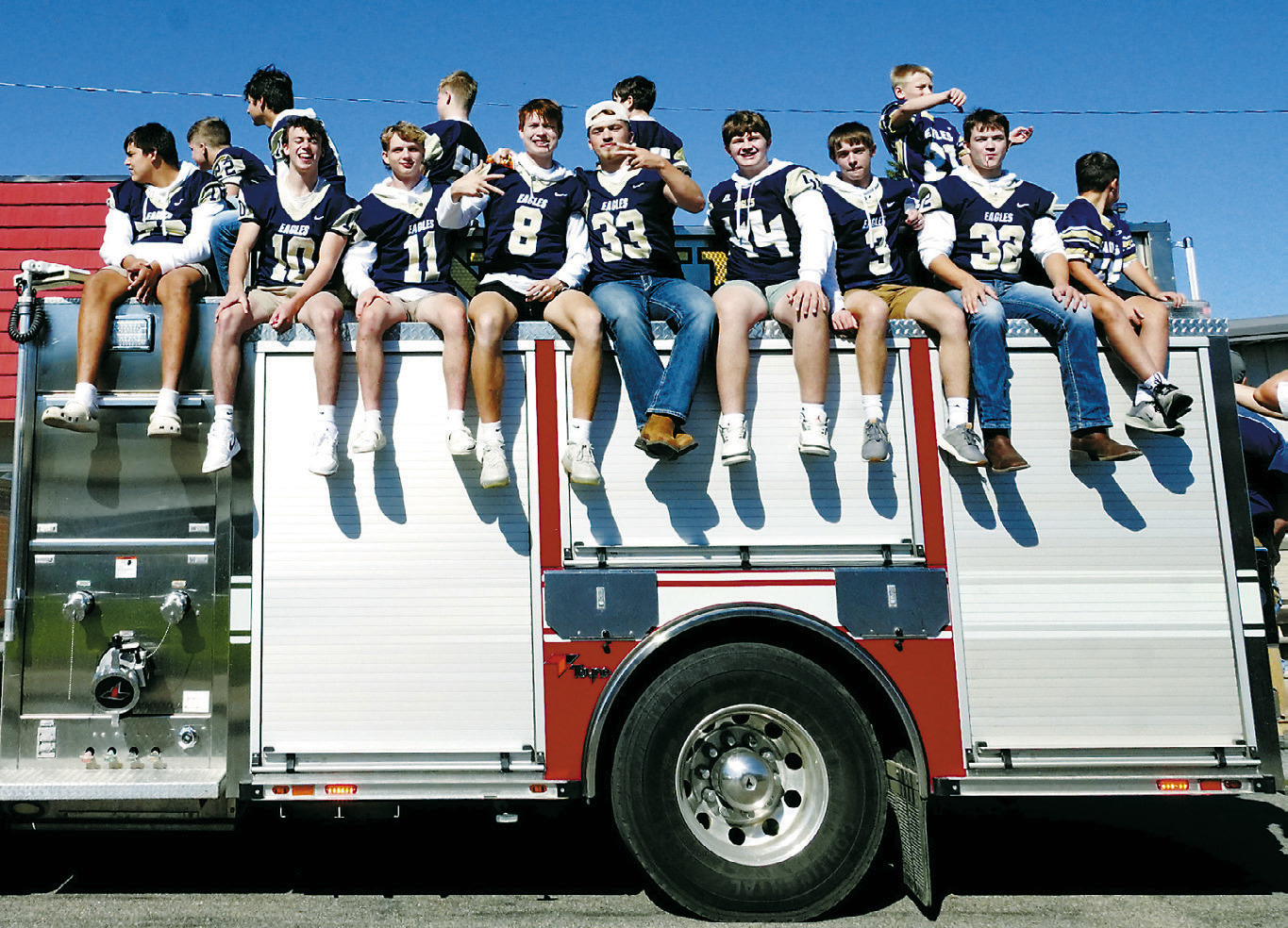 The North Border Eagles football team poses for a photo in the homecoming parade atop a firetruck. Photo by Larry Stokke.