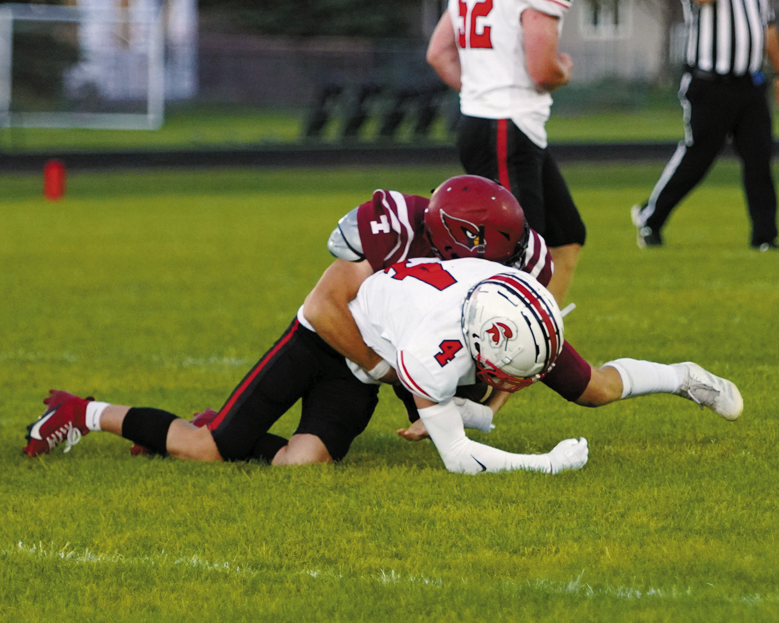 #4 Sam Davis tackles #4 Central Cass Anthony Garmen. Photo by Larry Stokke.