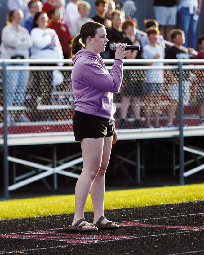 Madilyn Crump sang the Nation Anthem at the Cardinals first home football game. Photo by Larry Stokke.