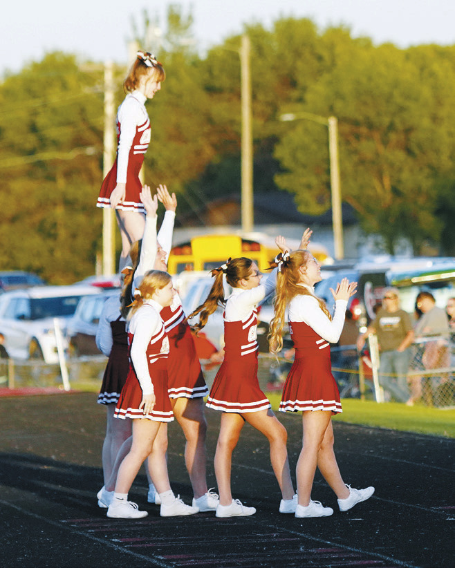 The Cardinals cheer team keeping the crowd pumped up. Photo by Larry Stokke.