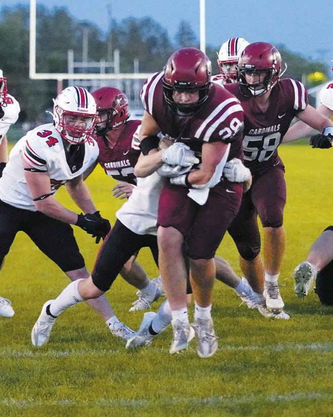 Theo Romfo makes a touchdown for the Cards. Photo by Larry Stokke.