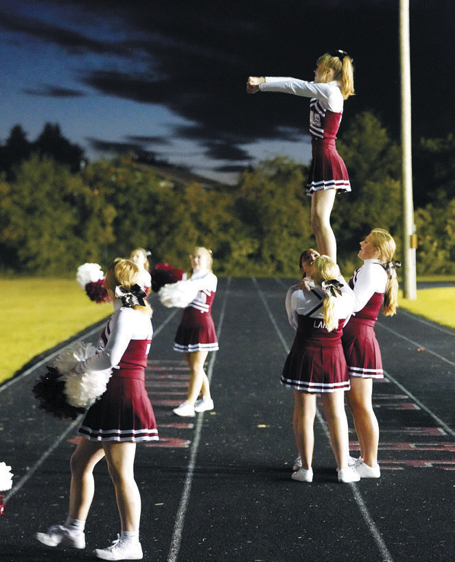 Cardinal cheerleaders keeping the crowd fired up at the game. Photo by Larry Stokke.