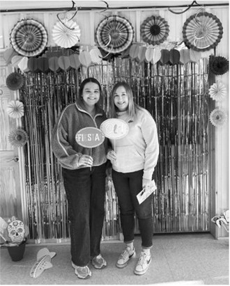 Josie Muhs and Jordyn Tetrault enjoy the photobooth at Dahl Trucking.
