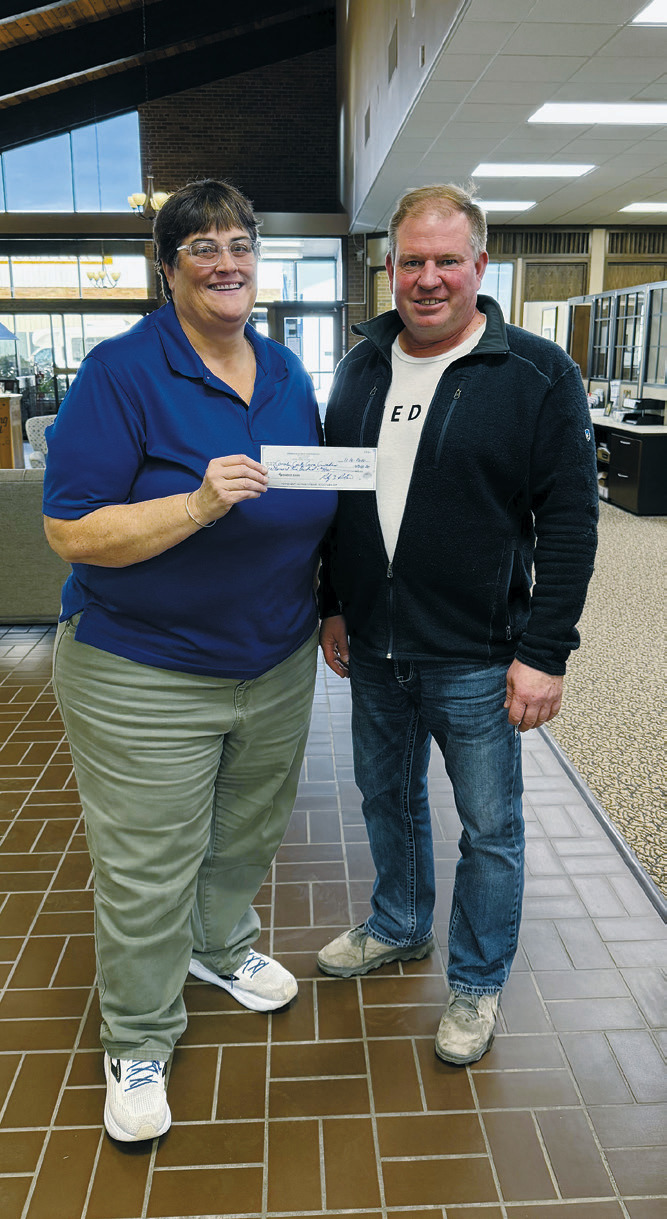 Mickey Cain with the Cavalier County Cancer Crusaders receives a check from Randy Bata with the Pembina Gorge Dirt Riders.