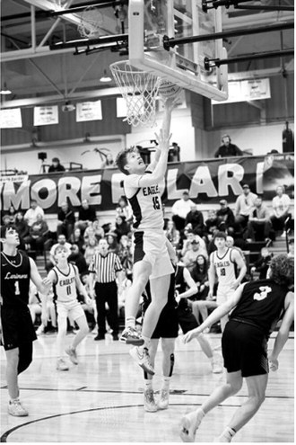 Garret Willits goes up strong for the layup. Photo by Ashley Schafer