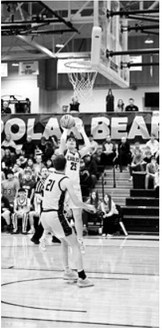Chase Mensch shoots in the paint over his defender. Photo by Ashley Schafer