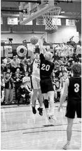 Brody Berg gets up for a double over an outstretched defender. Photo by Ashley Schafer