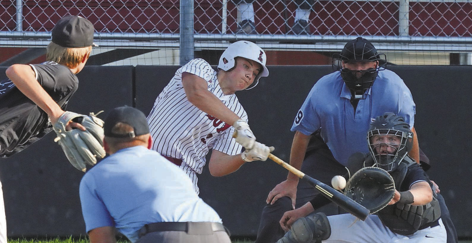 Landon Schneider connects for a base hit against Midway/Minto. PHOTO BY LARRY STOKKE.
