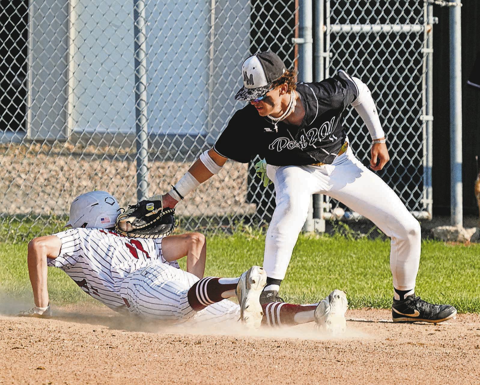 Cody Amble beats the tagout at first base in Langdon’s game against Midway/Minto. PHOTO BY LARRY STOKKE.