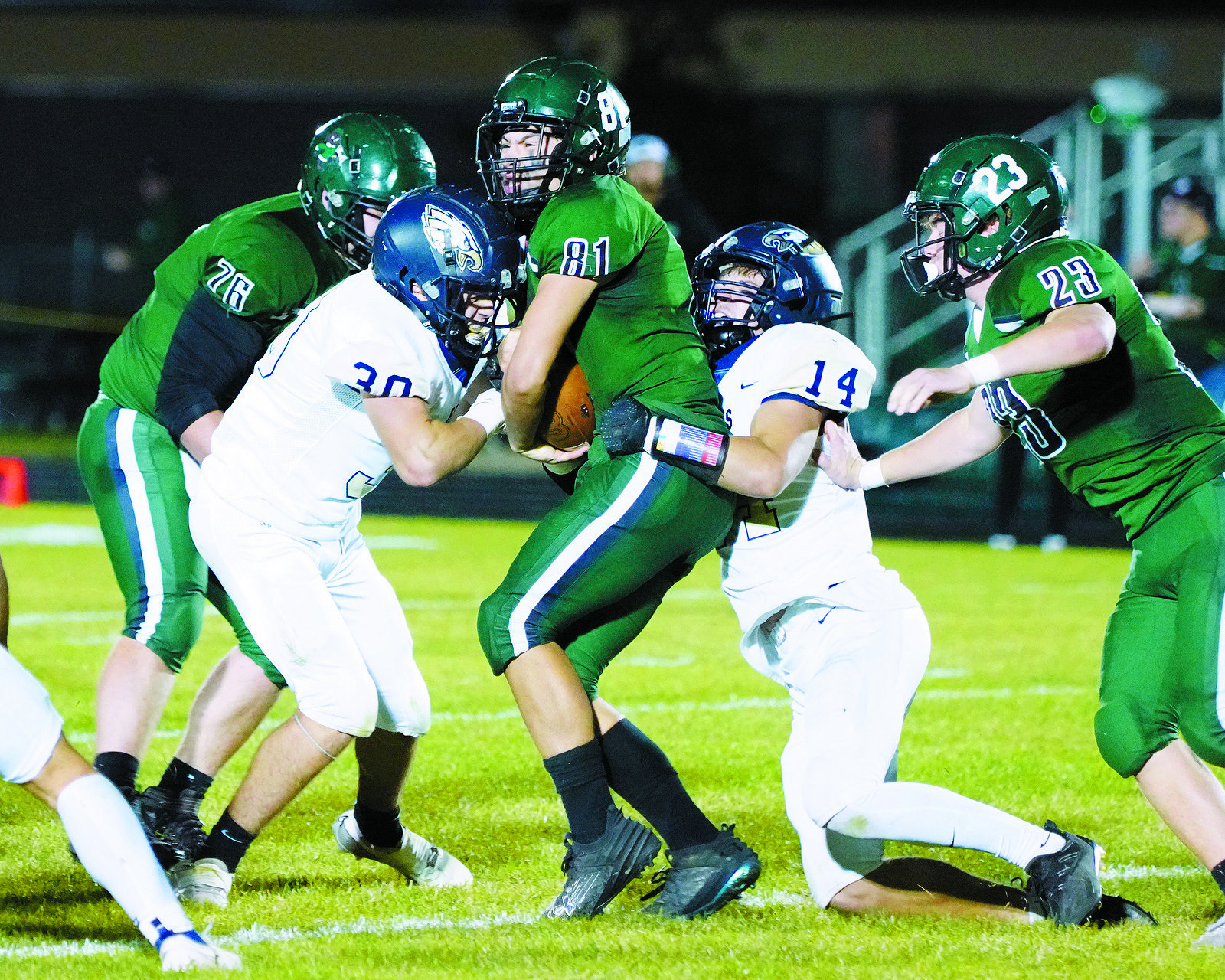 Brody Berg and Colton Bailey team up to stop any forward progress for the Woodchucks. Photo by Larry Stokke.