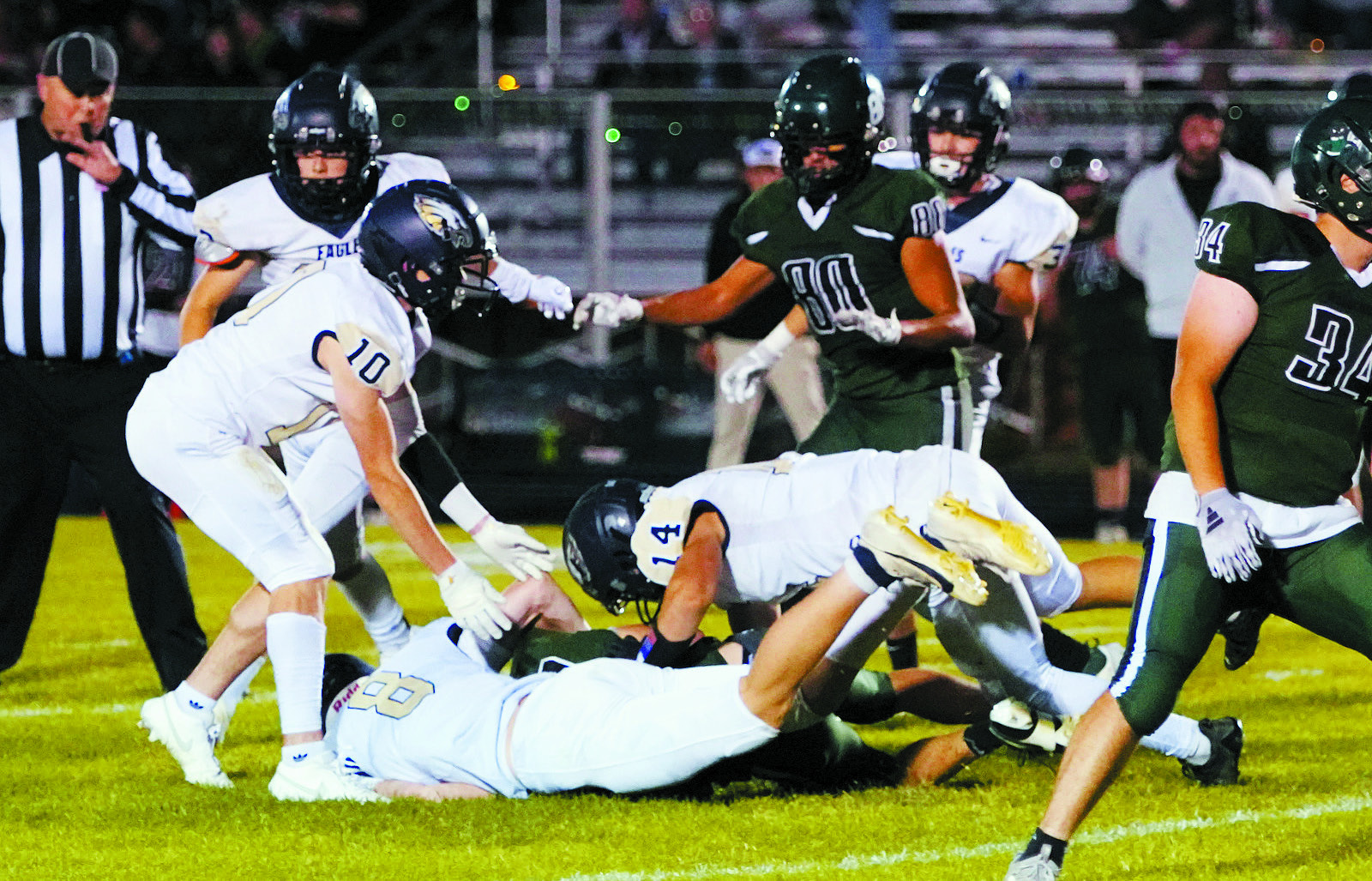Garrett Willits and Colton bailey team up and tackle a St John Woodchuck in the Eagles win over the Chucks. Photo by Larry Stokke.