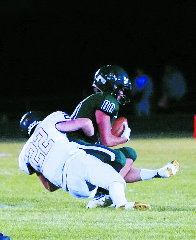 Zeke Symington tackles Kaden Preston for a turnover in downs. Photo by Larry Stokke.