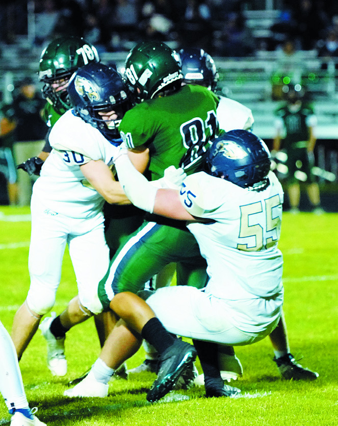 Gavin Symington and Brody Berg wrap up the Woodchucks Trey Laducer. Photo by Larry Stokke.