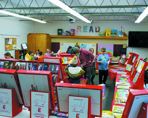 Students enjoy a book fair at St. Alphonsus School. Photo by Larry Stokke.