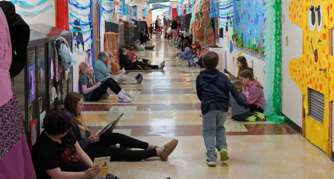 Students read in their brightly decorated hallways at Munich School. Photo by Larry Stokke.