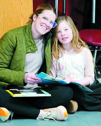 Megan Hursman reads with her daughter, Bailey. Photo by Larry Stokke.