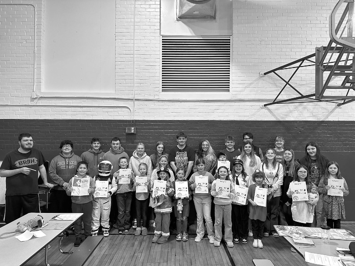 Second graders share their book “When I Grow Up” with graduating seniors during career day at North Border School in Walhalla, creating a full-circle moment as seniors reflected on the same assignment they completed nine years earlier. Submitted photo