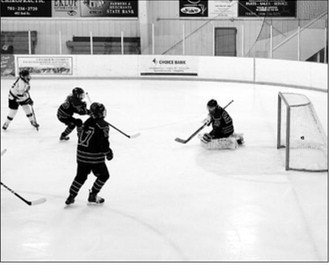 Colby Forest sends one of her two goals into the net in the game with Bottineau. Photo by Larry Stokke