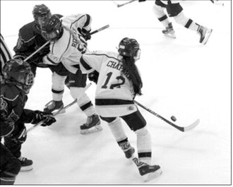 Aishwarya Chapara, with McKenzie Regner running blocker for her, brings the puck up ice in the game against Bottineau Feb 21st. Photo by Larry Stokke