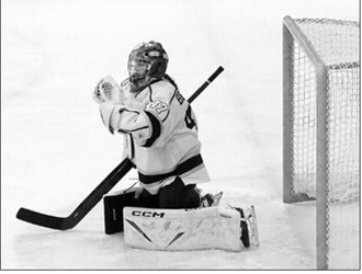 Ella Brekke makes a great glove save. She faced 64 shots on goal, stopping 61 of them. Photo by Larry Stokke