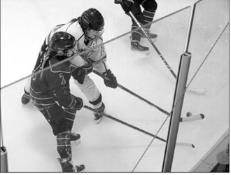 Kenadee Cluchie battles for control of the puck along the glass in the 3-3 OT game with Bottineau. Photo by Larry Stokke