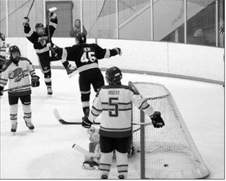 Ben Berg celebrates after getting the puck past the Northwood goalie to score one for the Blades. Photo by Larry Stokke