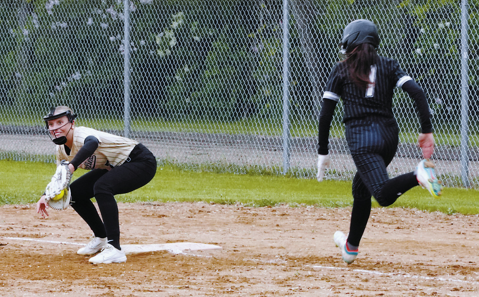 Hannah Russell with a catch and a put out at first base against Nelson County. Photo by Larry Stokke.