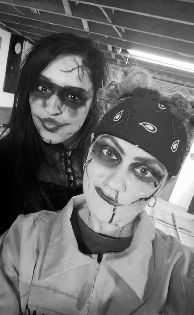Celica Gonzales and Sam Beck (orange) getting ready to put on a frightening night. Photo courtesy of Sam Beck.
