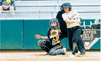 Hannah Russell connects for a base hit during the Grizzlies' game action. Photo by Larry Stokke