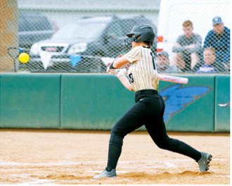 Averie Sondeland keeps her eye on the ball before driving it into the outfield during the Grizzlies' game against Glenburn. Sondeland went 2-for-4 with two RBIs in the contest. Photo by Larry Stokke