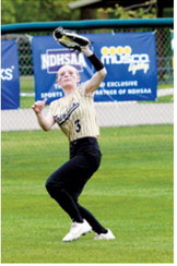 Kendra Briese tracks down a fly ball and makes a running catch deep in left field for an out during the Grizzlies' game against Central Cass at the State Softball Tournament. Photo by Larry Stokke