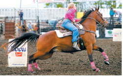 Carmyn LeTexier of Cavalier rounds the first barrel during the barrel racing competition at the Wojo Rodeo on June 12 in Hamilton. Photo by Larry Stokke