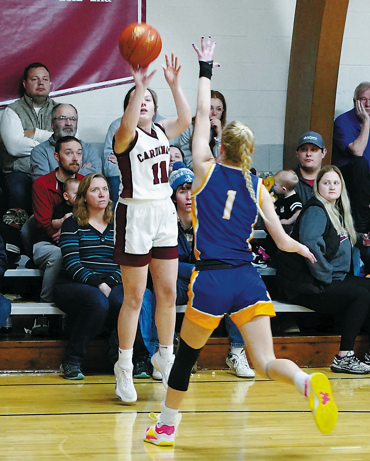 Mikaela Olson eyes the basket and fires off a three point shot against Benson County. Erika Bakke with a defender's hand in front of her nails a 3-point basket. Photo by Larry Stokke. Photo by Larry Stokke.