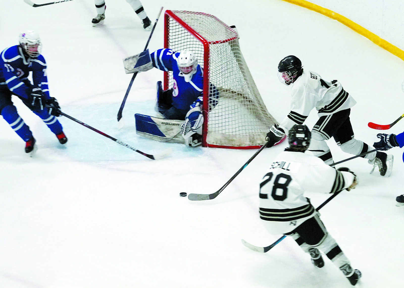 Benjamin Berg brings the puck around the side of the net to try a shot in the Jr Gold game. Photo by Larry Stokke.