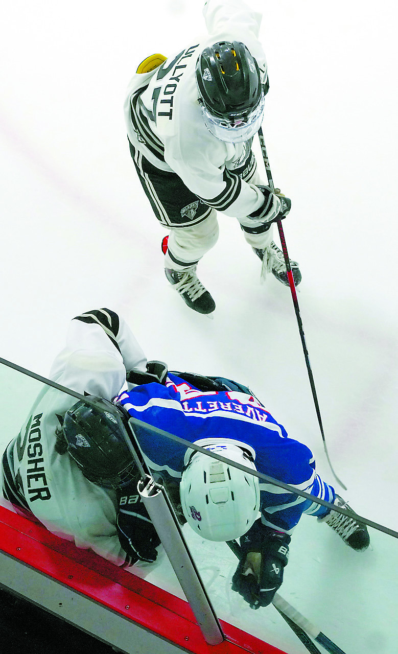 Carter Mosher tangles with a Ranger player for control of the puck. Photo by Larry Stokke.