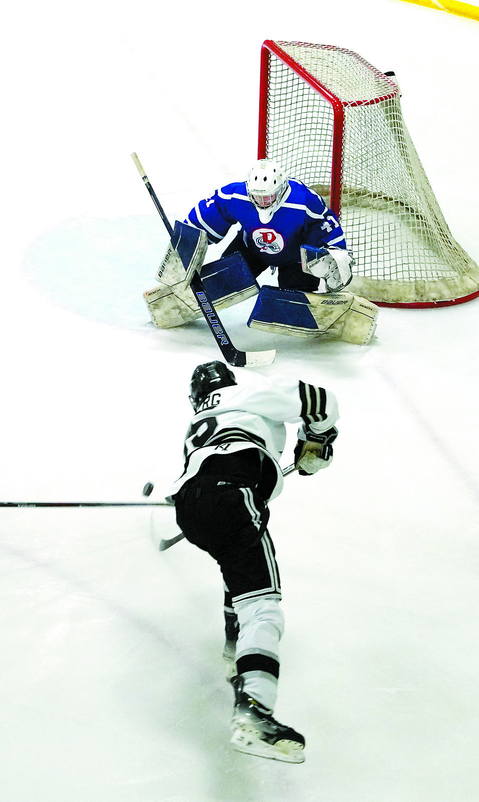 Ty Ramberg skates in and tries to get the puck past the Richland goalie. Photo by Larry Stokke.