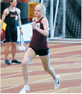 Mya Swanson runs to a sixth place finish in the 600 in Grand Forks on March 27. Photo by Larry Stokke