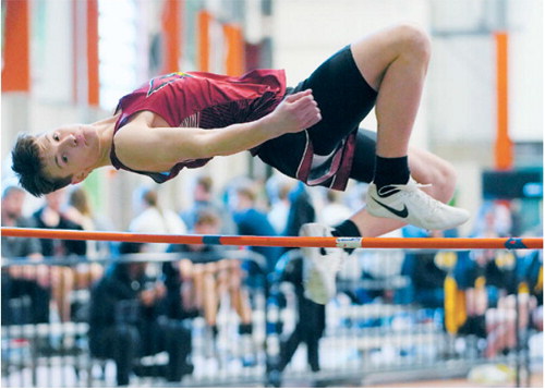 Tyler Borgen clears the high jump bar with room to spare on March 27. Photo by Larry Stokke