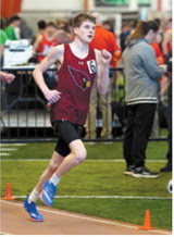 Kaleb Foster makes his way around the track at the meet on March 27. Photo by Larry Stokke