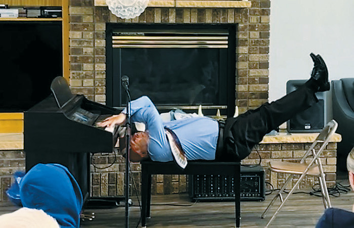 Gordy “Crazy Fingers” Lindquist playing one of his most iconic performances - playing the piano while laying on his back! Photo by Heather Duerre.
