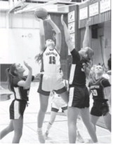 Taya Feist drops one in, gets fouled, and adds a free throw for a 3 point play. Photo by Larry Stokke.