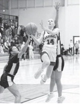 Hillary Haaven drives in for a layup, is fouled, and drains two free throws. She had a team high 9 points against the Tommies. Photo by Larry Stokke.