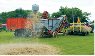 An antique McCormick threshing machine demonstrates how grain was separated from straw during the ninth annual Picnic at the Museum and Threshing Event on July 19 at the Cavalier County Historical Society Museum in Dresden. Live threshing demonstrations were among the day's featured attractions. Photo by Larry Stokke