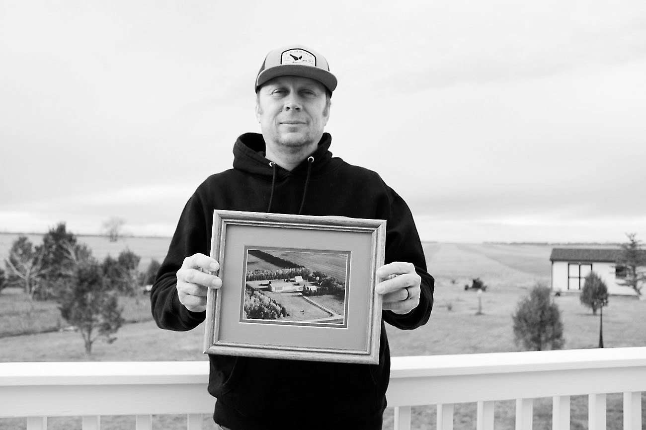 Farmer Tyler Stafslien stands in front of storage silos holding grain and soybeans in Ryder, North Dakota on Nov. 14, 2025. The tariff war with China forced Stafslien to store more of his soybeans this harvest season. (Photo: Gabrielle Nelson/Buffalo’s Fire)